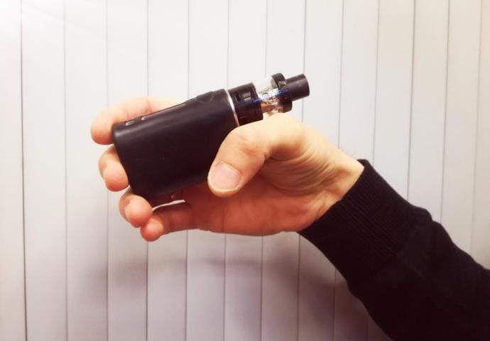 Image of an overheated or bulging vape battery, possibly emitting smoke or sparks, representing the dangerous phenomenon of thermal runaway.